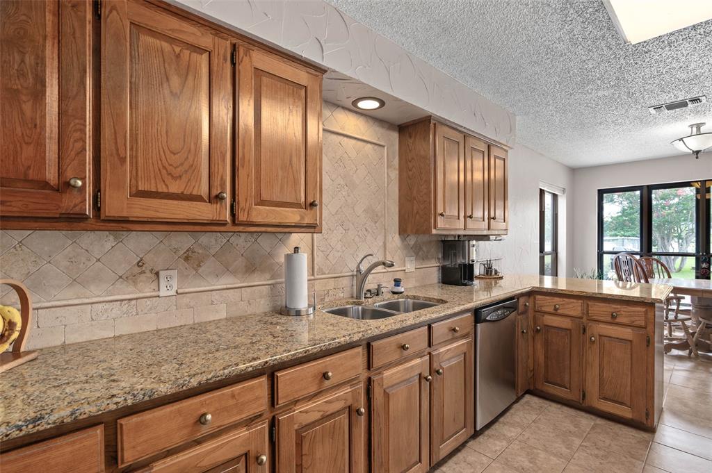 108 Carlin Road Mansfield, TX 76063 - Photo 9 of 40 a kitchen with stainless steel appliances granite countertop a sink stove and cabinets