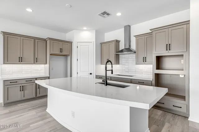 a kitchen with stainless steel appliances granite countertop a sink and stove
