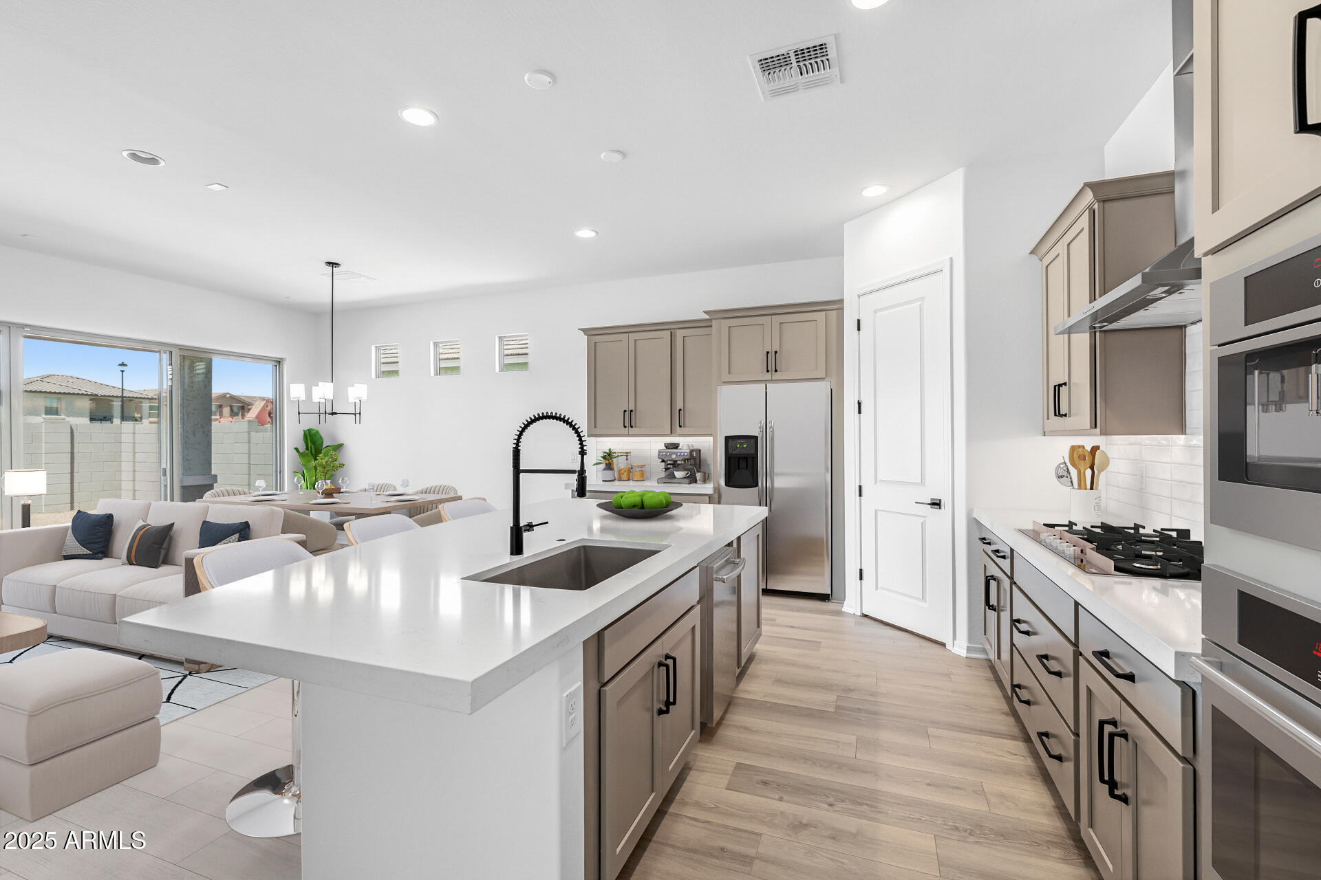 4252 East Bernice Street Gilbert, AZ 85295 - Photo 16 of 72 a kitchen with kitchen island white cabinets and stainless steel appliances