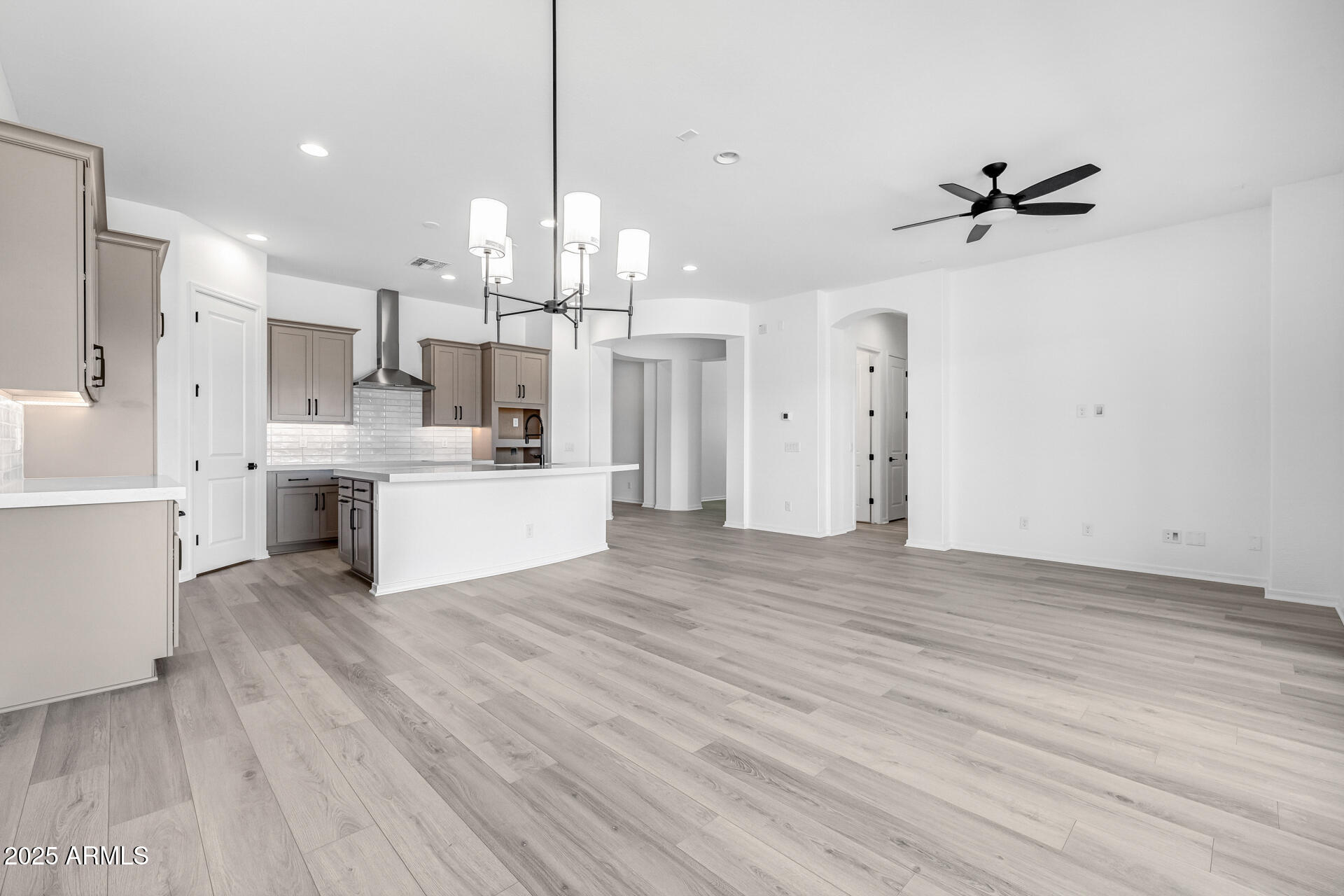 4252 East Bernice Street Gilbert, AZ 85295 - Photo 23 of 72 a view of a kitchen with kitchen island wooden floors stainless steel appliances and cabinets