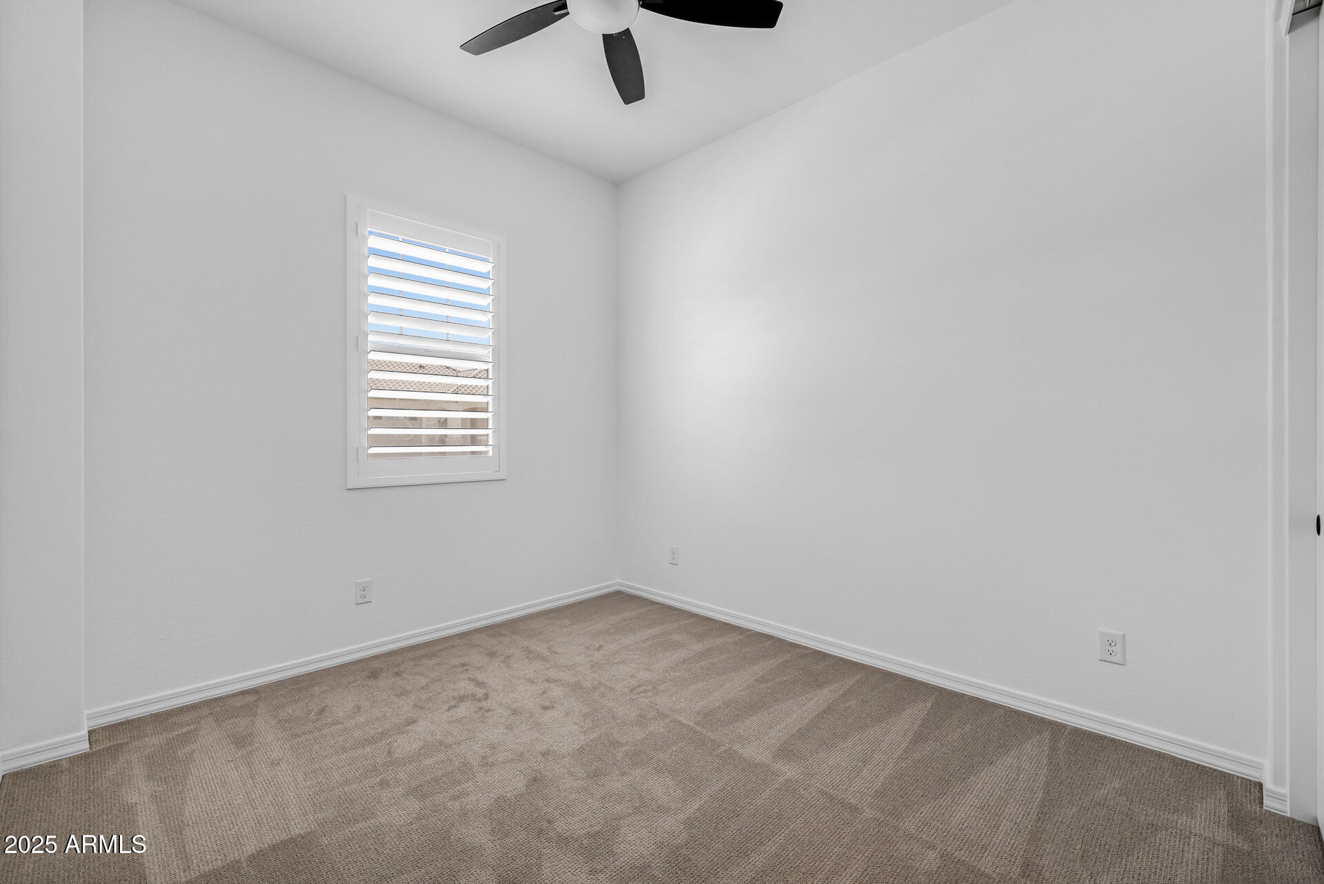 4252 East Bernice Street Gilbert, AZ 85295 - Photo 30 of 72 an empty room with a window and a fan