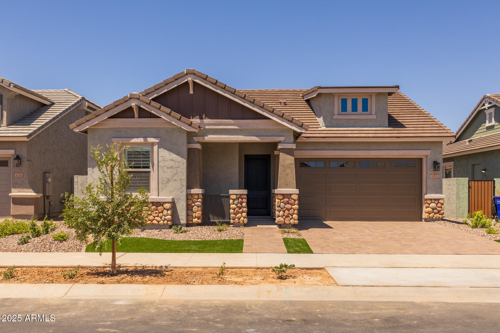 4252 East Bernice Street Gilbert, AZ 85295 - Photo 46 of 72 a front view of a house with a garden and garage