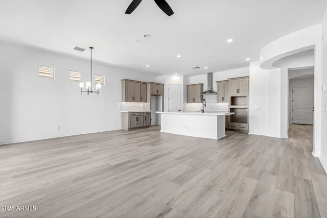 a kitchen with stainless steel appliances granite countertop a sink a stove and a refrigerator