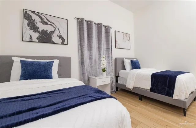 a bedroom with a bed and wooden floor