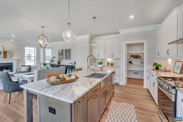 a kitchen with a sink stove and cabinets