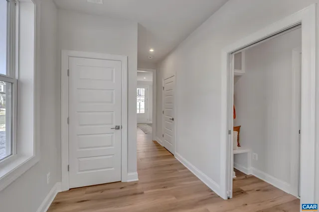a view of hallway with wooden floor