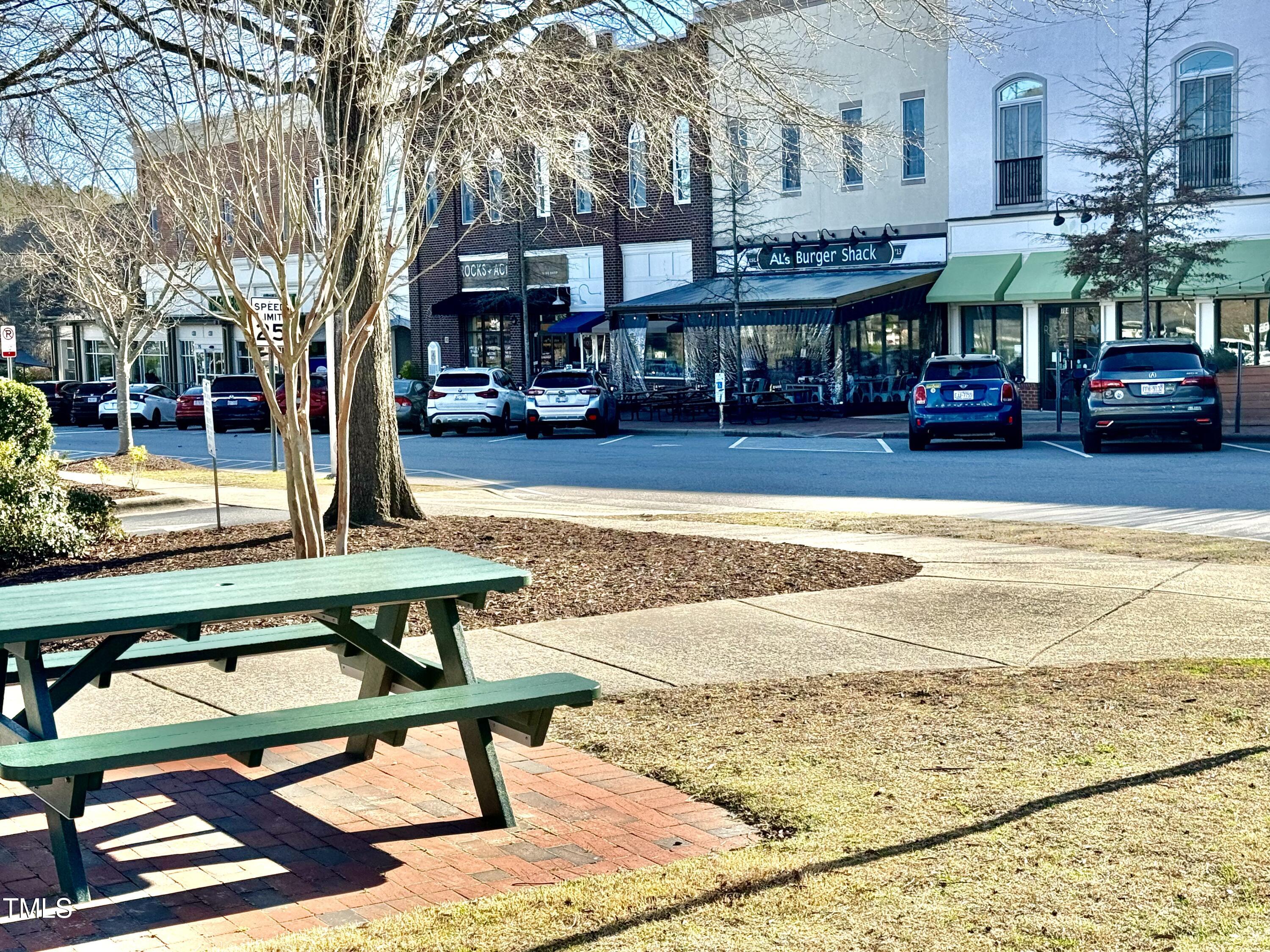 522 Aberdeen Drive, Unit 106 Chapel Hill, NC 27516 - Photo 50 of 68 a view of a water fountain in front of building with a lot of cars parked on the roadside