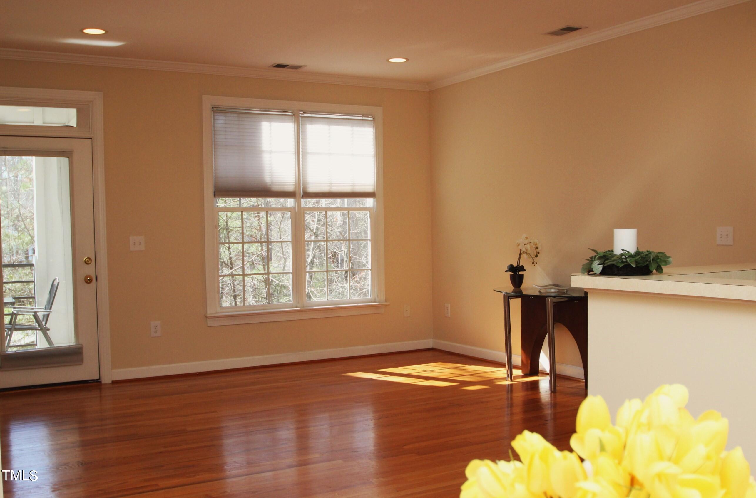 522 Aberdeen Drive, Unit 106 Chapel Hill, NC 27516 - Photo 57 of 68 a view of a livingroom with wooden floor and a window