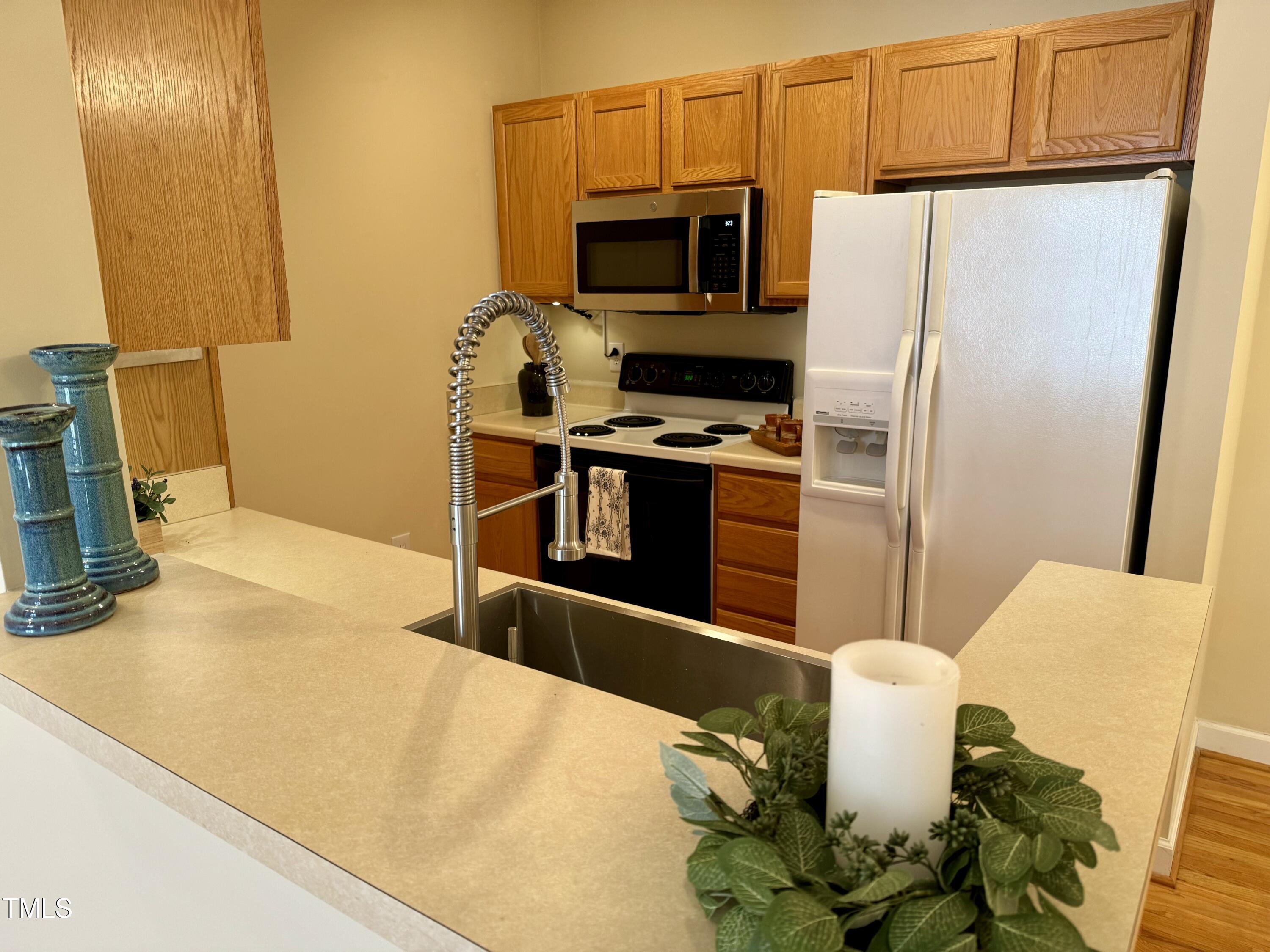 522 Aberdeen Drive, Unit 106 Chapel Hill, NC 27516 - Photo 8 of 68 a kitchen with stainless steel appliances a stove a microwave and a refrigerator