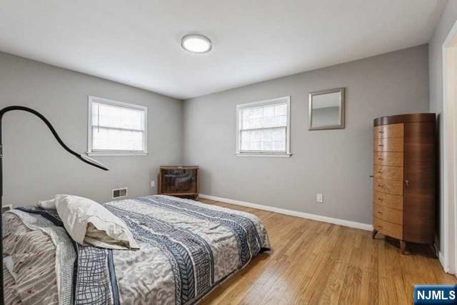 23 Asmus Road Closter, NJ 07624 - Photo 14 of 38 a bedroom with a bed and a wooden floor