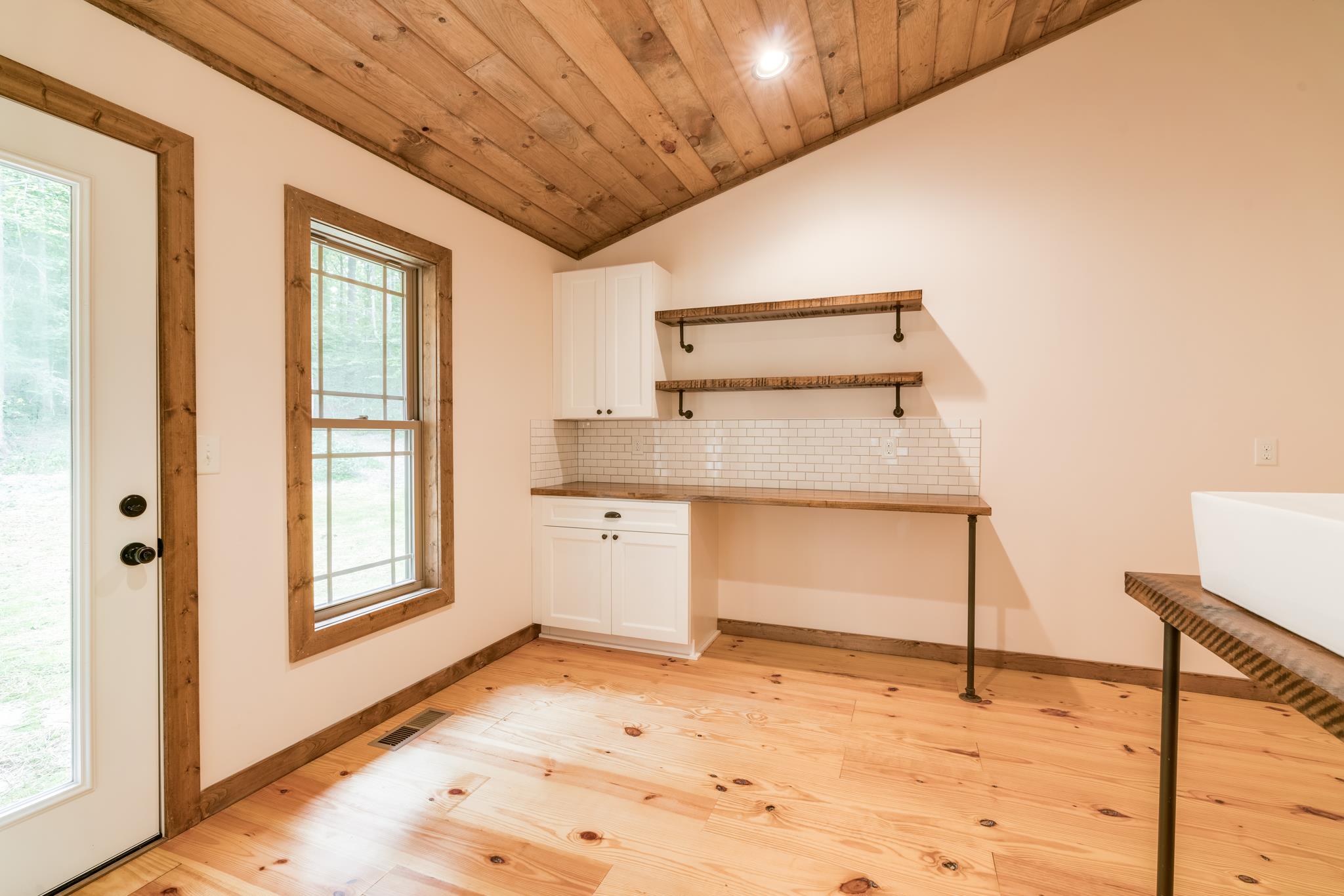 5475 Parker Branch Road Franklin, TN 37064 - Photo 18 of 29 Large laundry room on the main floor with storage, sink, and walk out access to the backyard