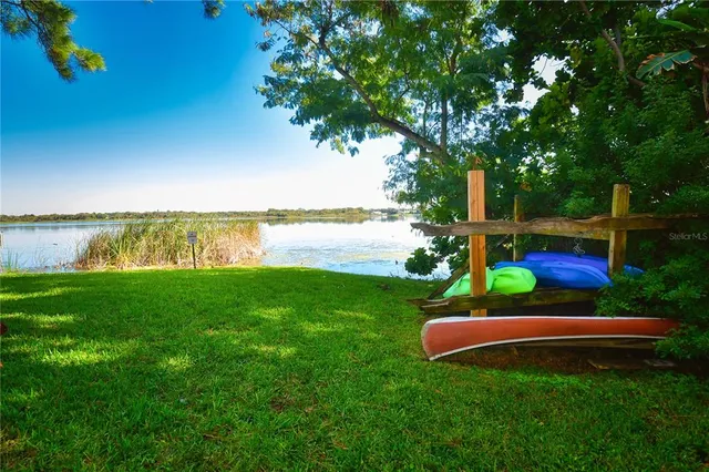 a view of a yard with a wooden fence