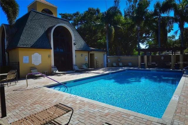a view of a house with backyard and swimming pool