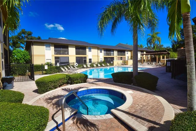 a large swimming pool with outdoor seating