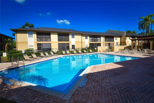 a view of a patio with table and chairs with wooden floor and plants