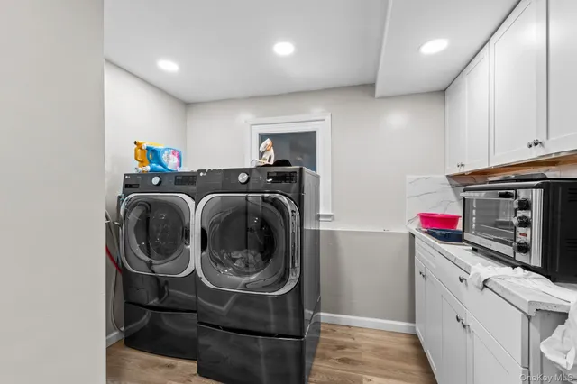 a utility room with sink dryer and washer