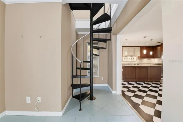 a kitchen with a checkered floor and white cabinets