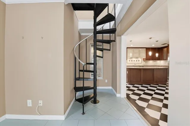 a kitchen with a checkered floor and white cabinets