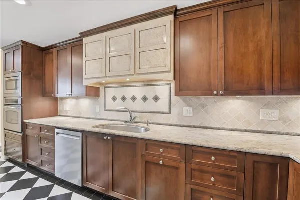 a kitchen with stainless steel appliances granite countertop a stove microwave and refrigerator