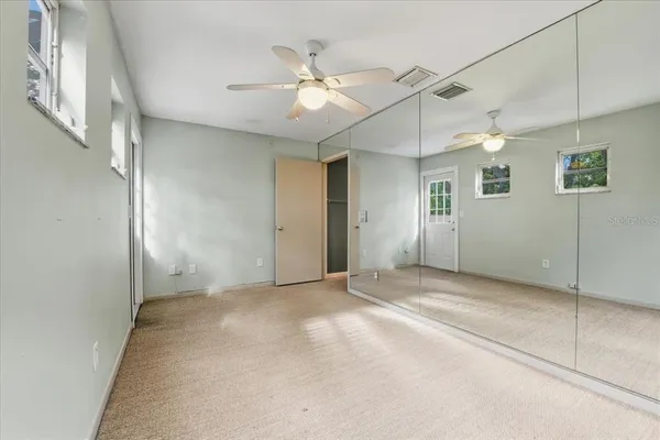a bathroom with a granite countertop toilet mirror and vanity