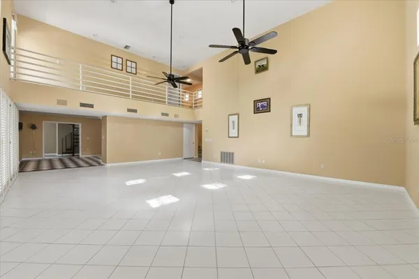 a view of a livingroom with an empty space and a ceiling fan
