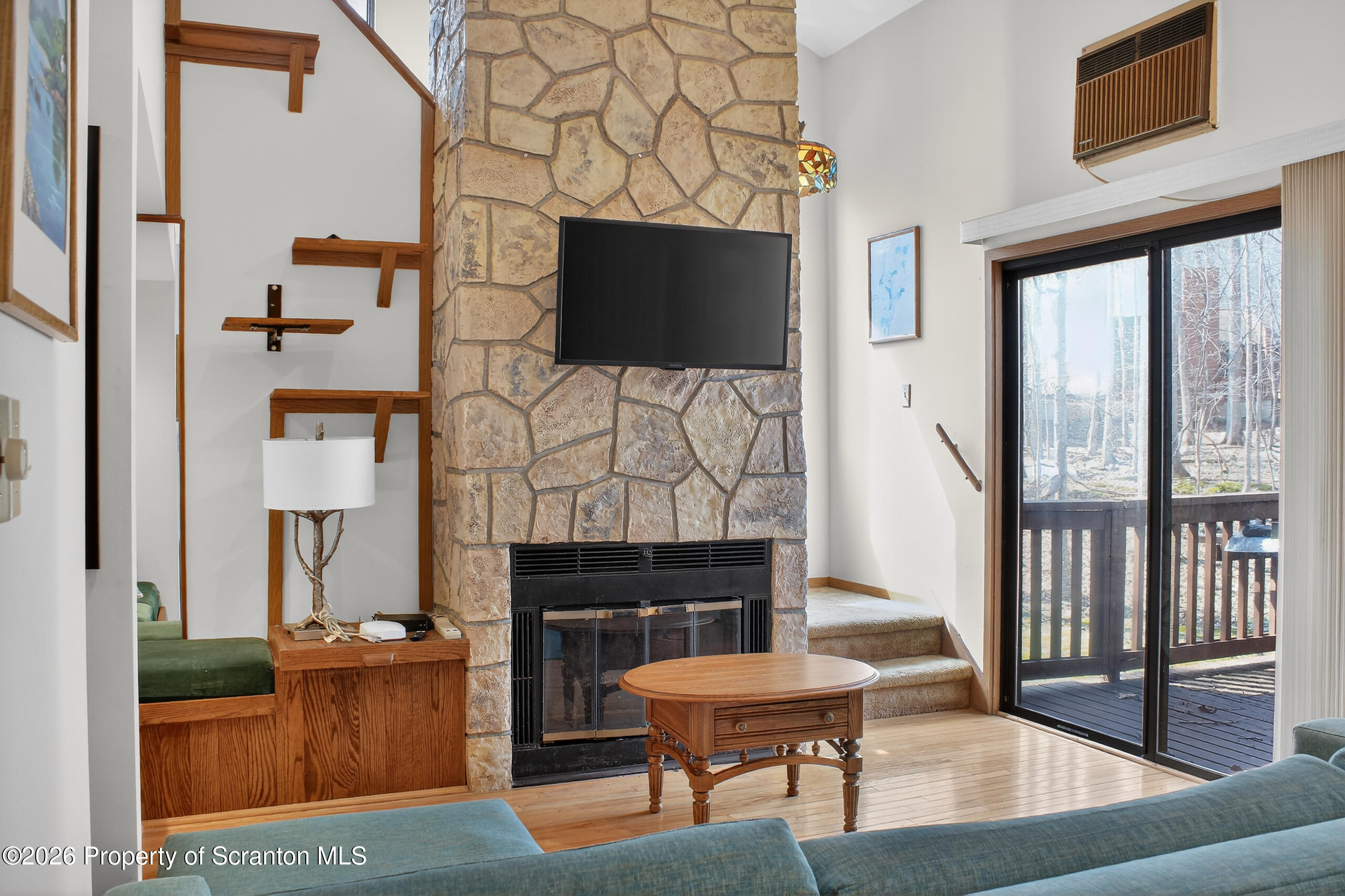 211 Falls Circle Bushkill, PA 18324 - Photo 10 of 28 a living room with furniture a flat screen tv and a fireplace