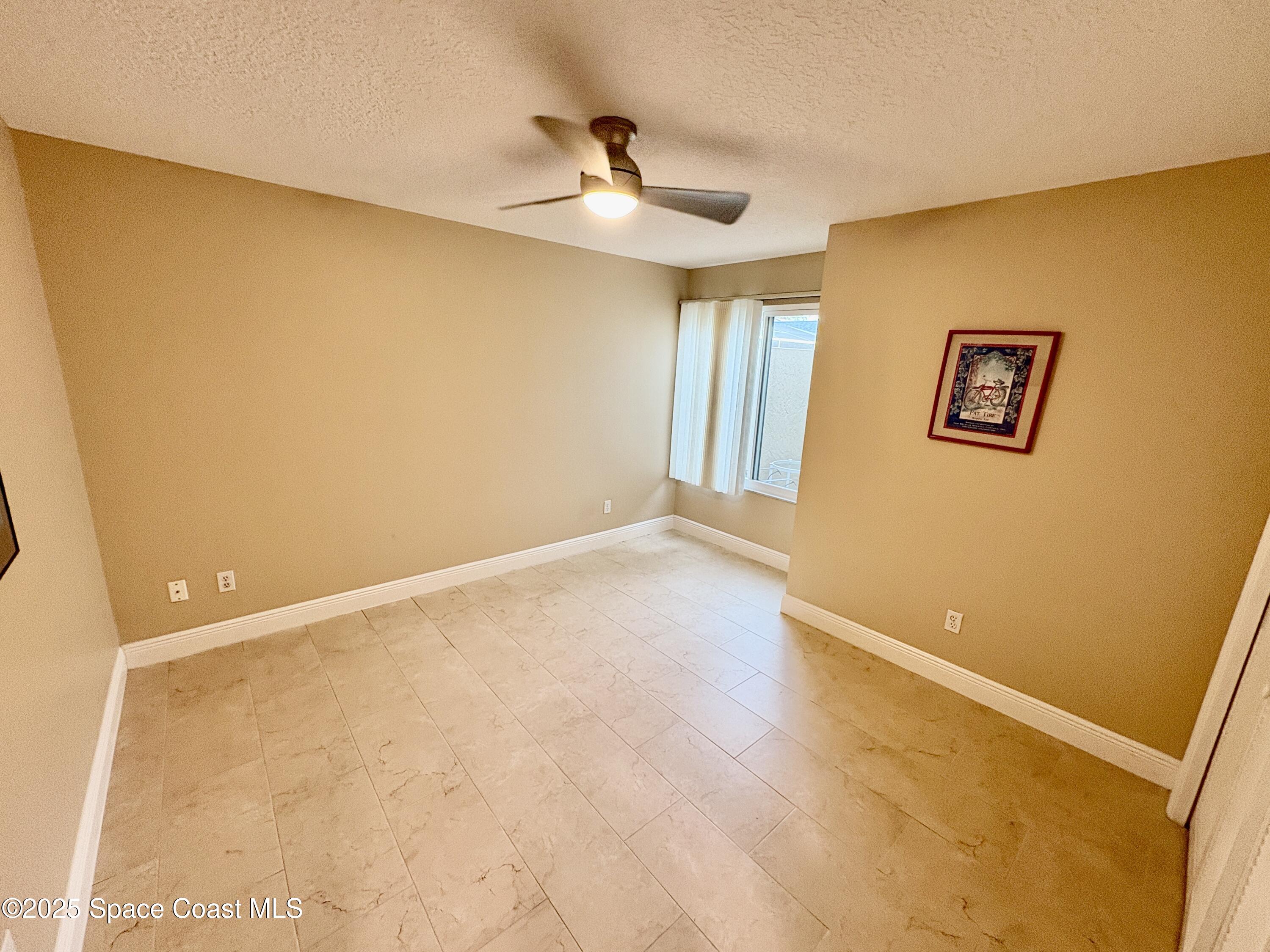 349 Country Walk Street Melbourne, FL 32940 - Photo 15 of 20 a view of an empty room with a window