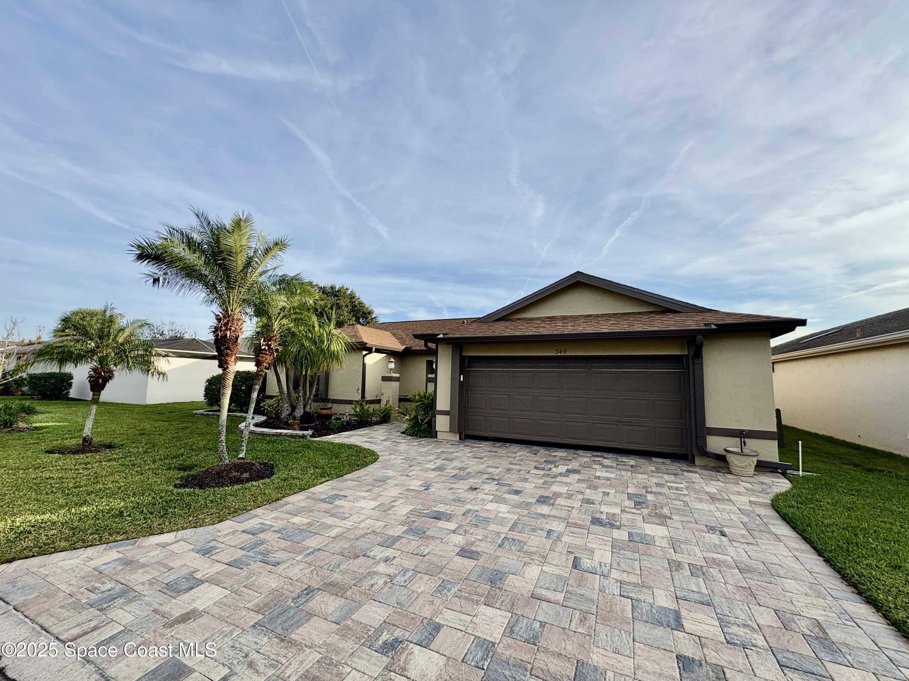 349 Country Walk Street Melbourne, FL 32940 - Photo 20 of 20 a front view of a house with a yard and garage