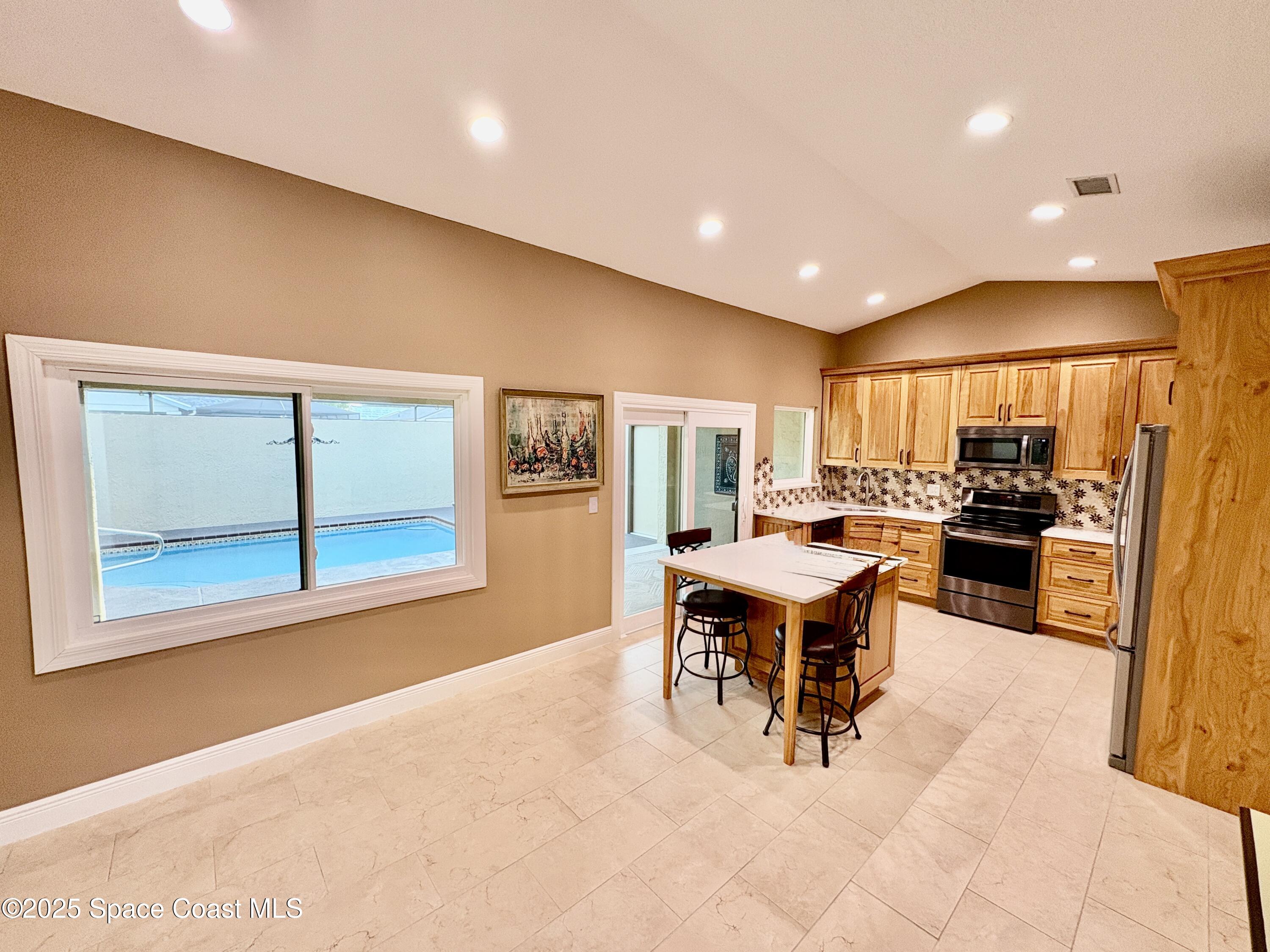 349 Country Walk Street Melbourne, FL 32940 - Photo 5 of 20 a living room with a kitchen island furniture and a large window