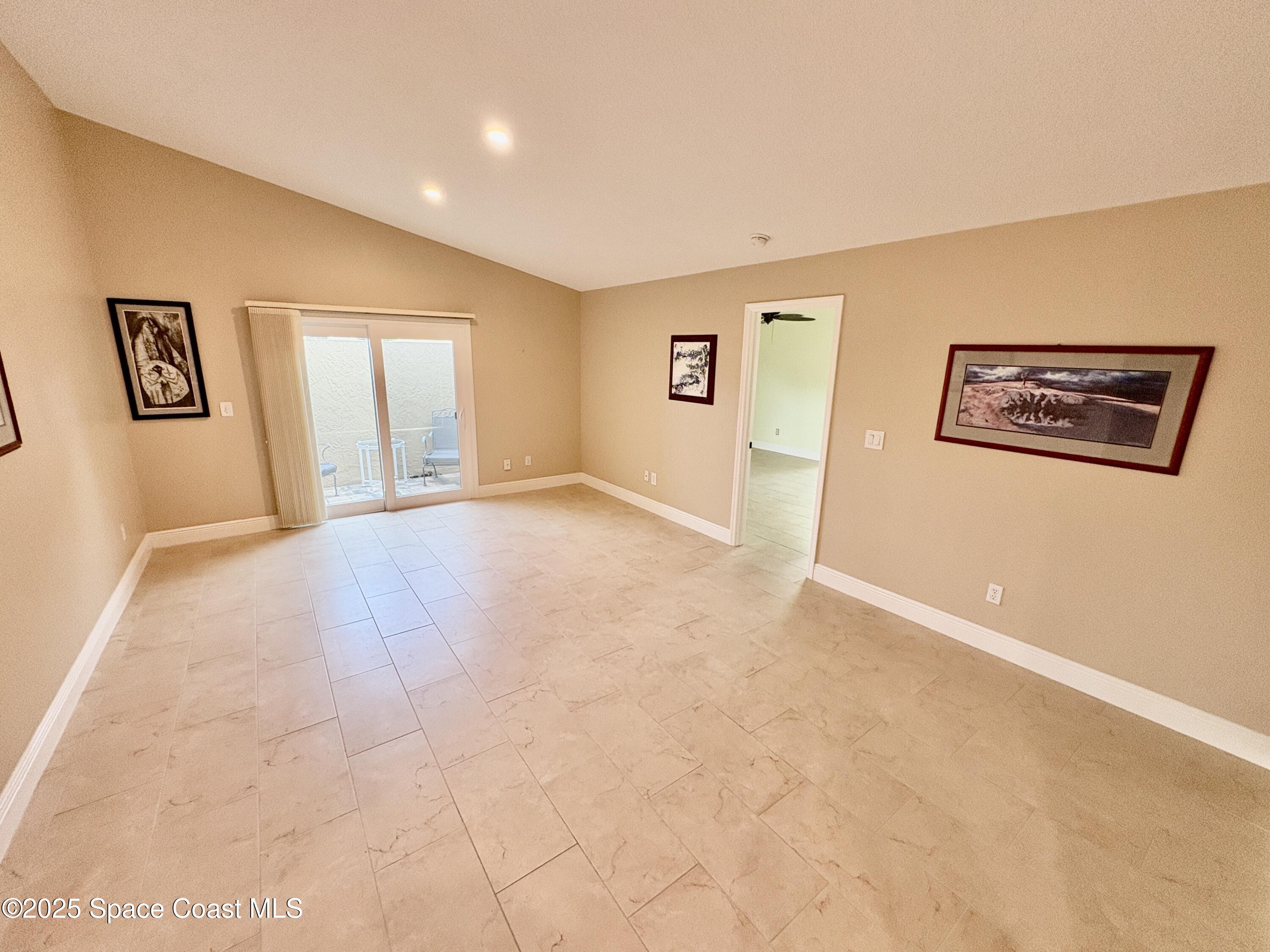 349 Country Walk Street Melbourne, FL 32940 - Photo 6 of 20 a view of an empty room with windows