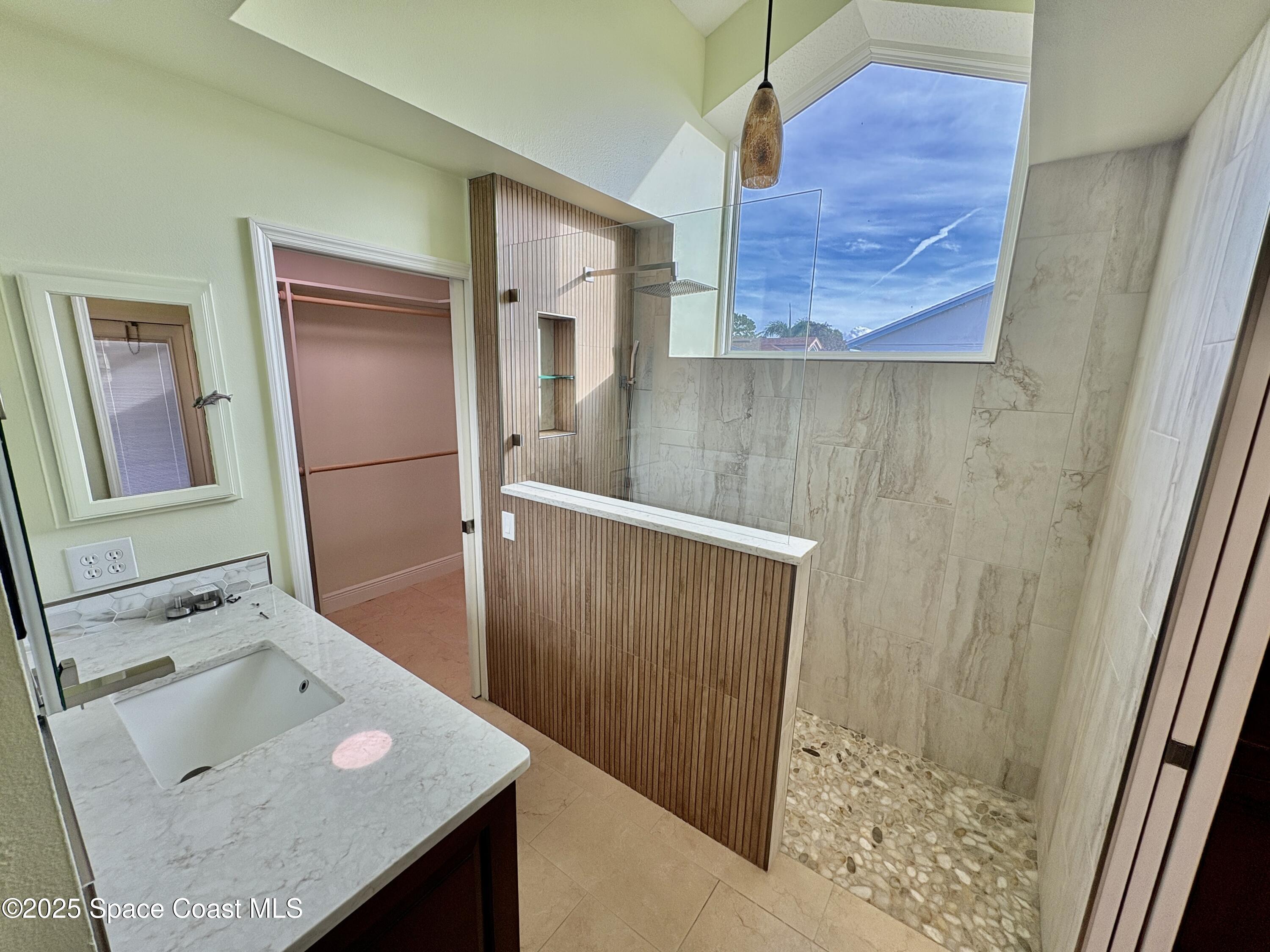 349 Country Walk Street Melbourne, FL 32940 - Photo 9 of 20 a bathroom with a sink a mirror and shower