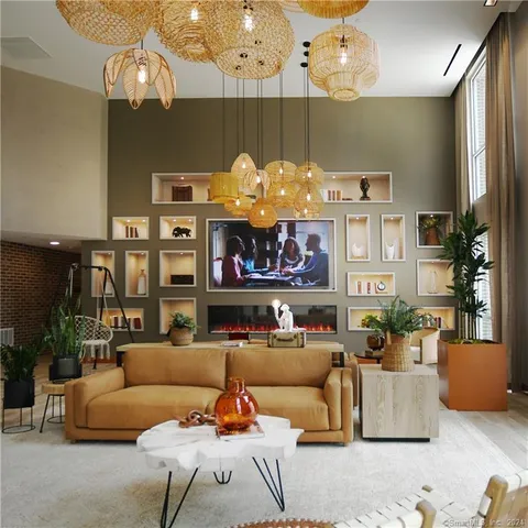 a living room with furniture kitchen view and a chandelier