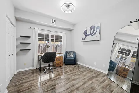 a view of a workspace with furniture and a window