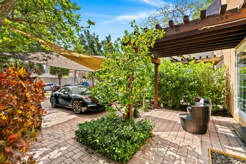 a view of a patio with table and chairs and potted plants