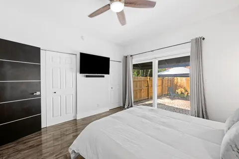 a bedroom with a bed and a flat screen tv