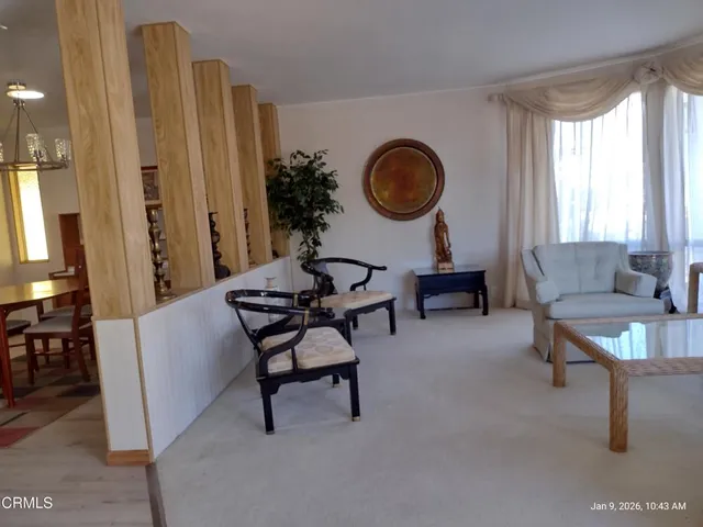 a kitchen with white cabinets and sink