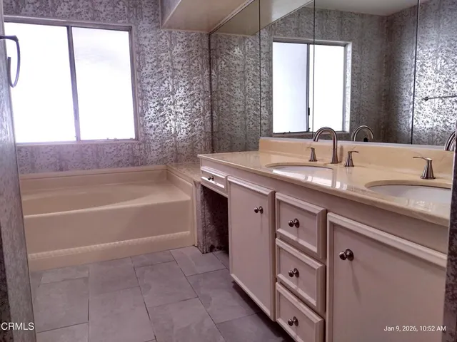 a bathroom with a granite countertop toilet and a shower