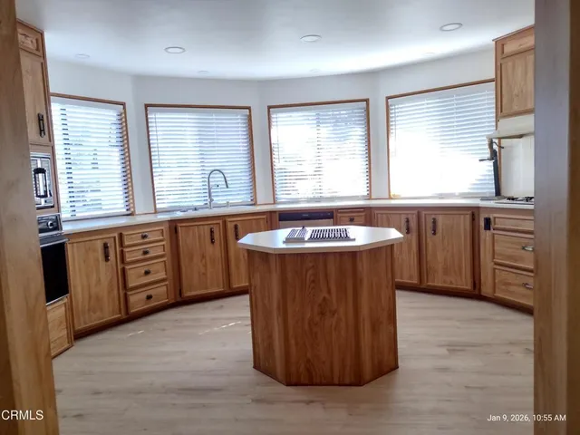 a spacious bathroom with a tub sink and mirror