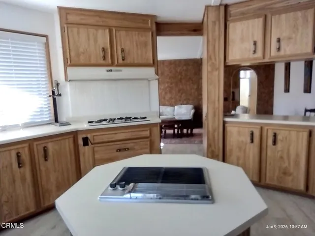 a kitchen with sink and cabinets