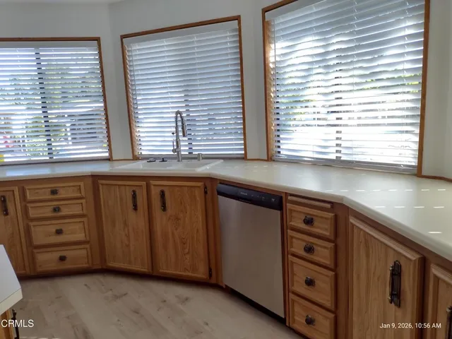 a kitchen with granite countertop cabinets and a large window