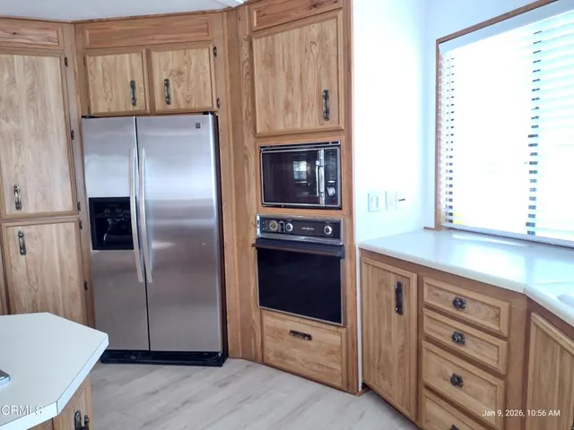 a kitchen with granite countertop a refrigerator and a stove