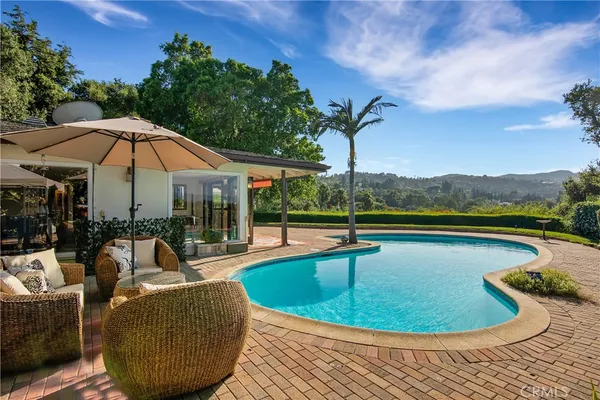 a view of a swimming pool with lounge chair