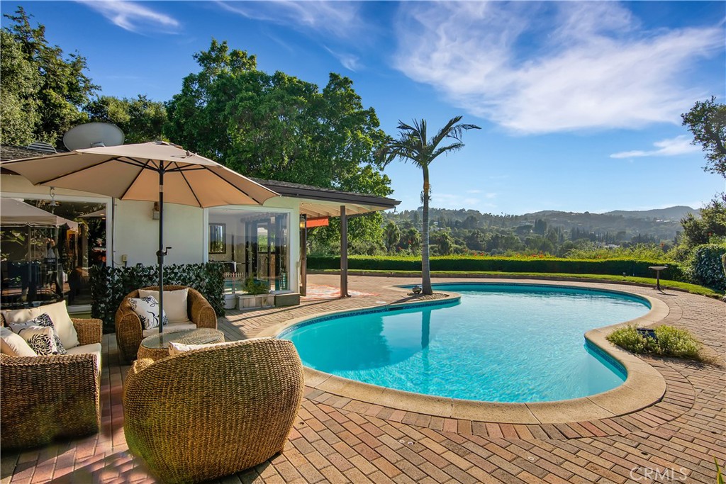 a view of a swimming pool with lounge chair