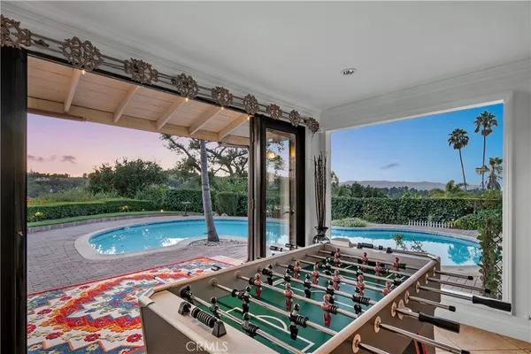 an aerial view of a house with swimming pool and outdoor space