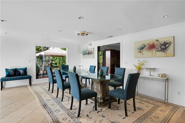 a living room with furniture a flat screen tv and a floor to ceiling window