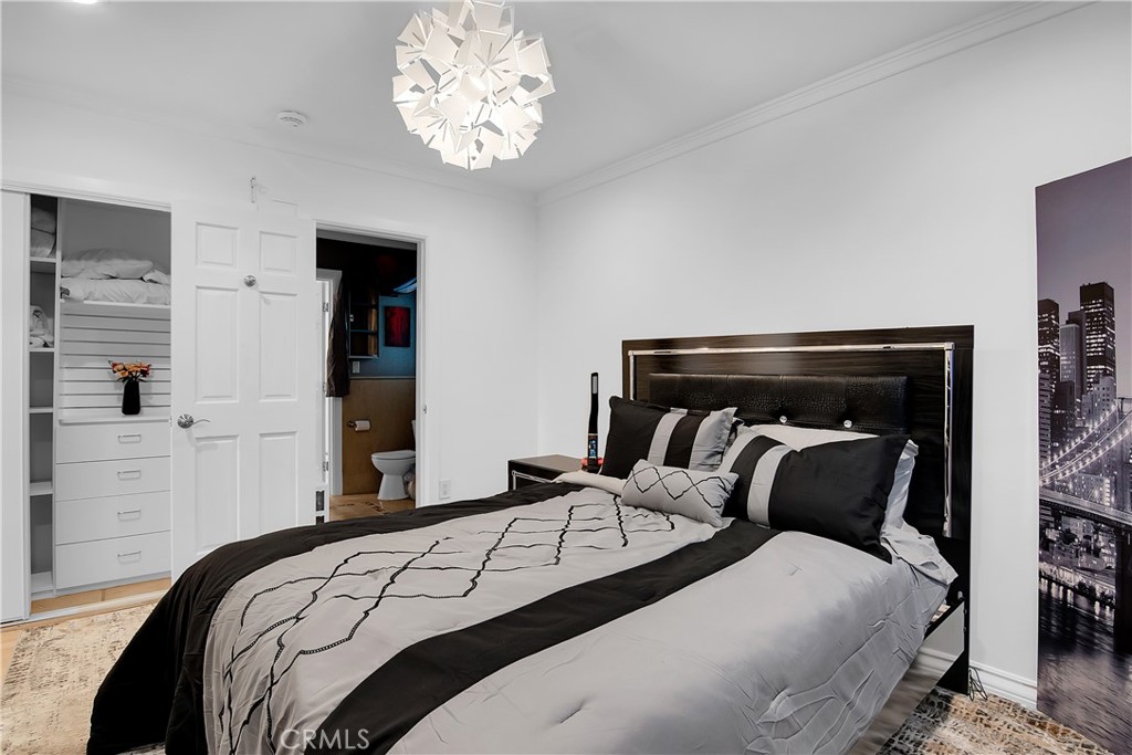 3701 Royal Meadow Road Sherman Oaks, CA 91403 - Photo 29 of 43 a bedroom with a bed and a chandelier