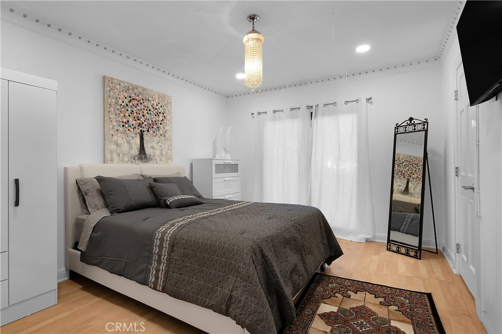 3701 Royal Meadow Road Sherman Oaks, CA 91403 - Photo 30 of 43 a bedroom with a large bed and a chandelier