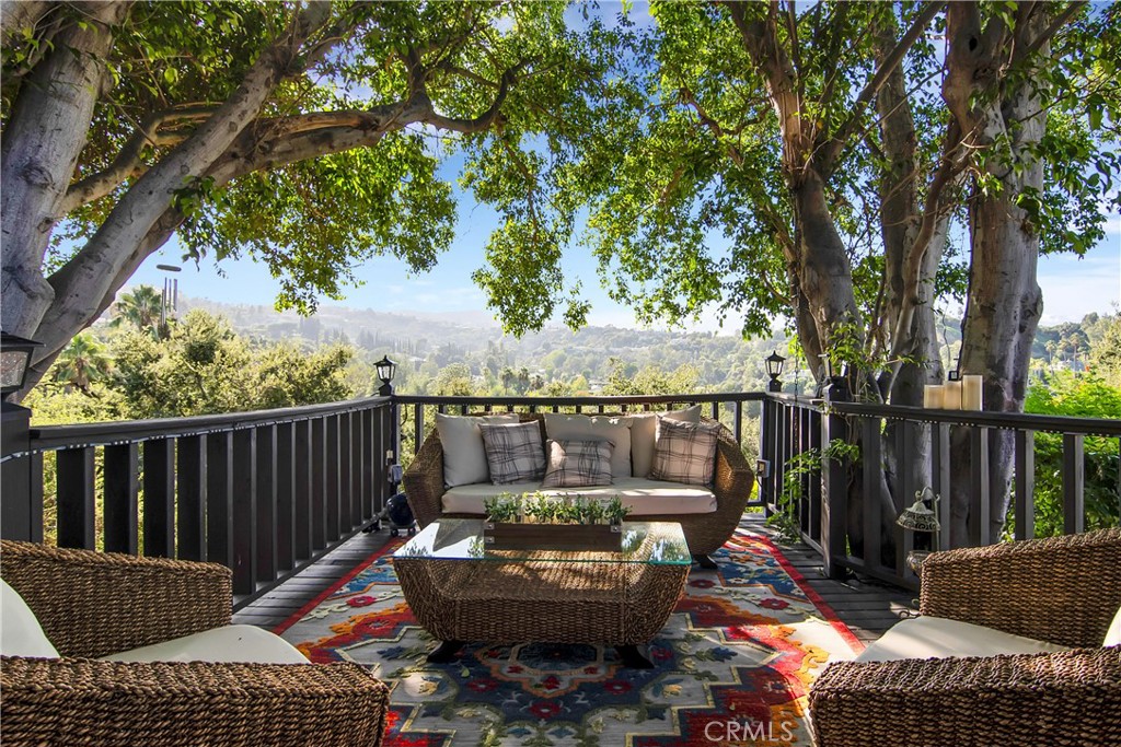 3701 Royal Meadow Road Sherman Oaks, CA 91403 - Photo 36 of 43 a view of a balcony with chairs and wooden fence