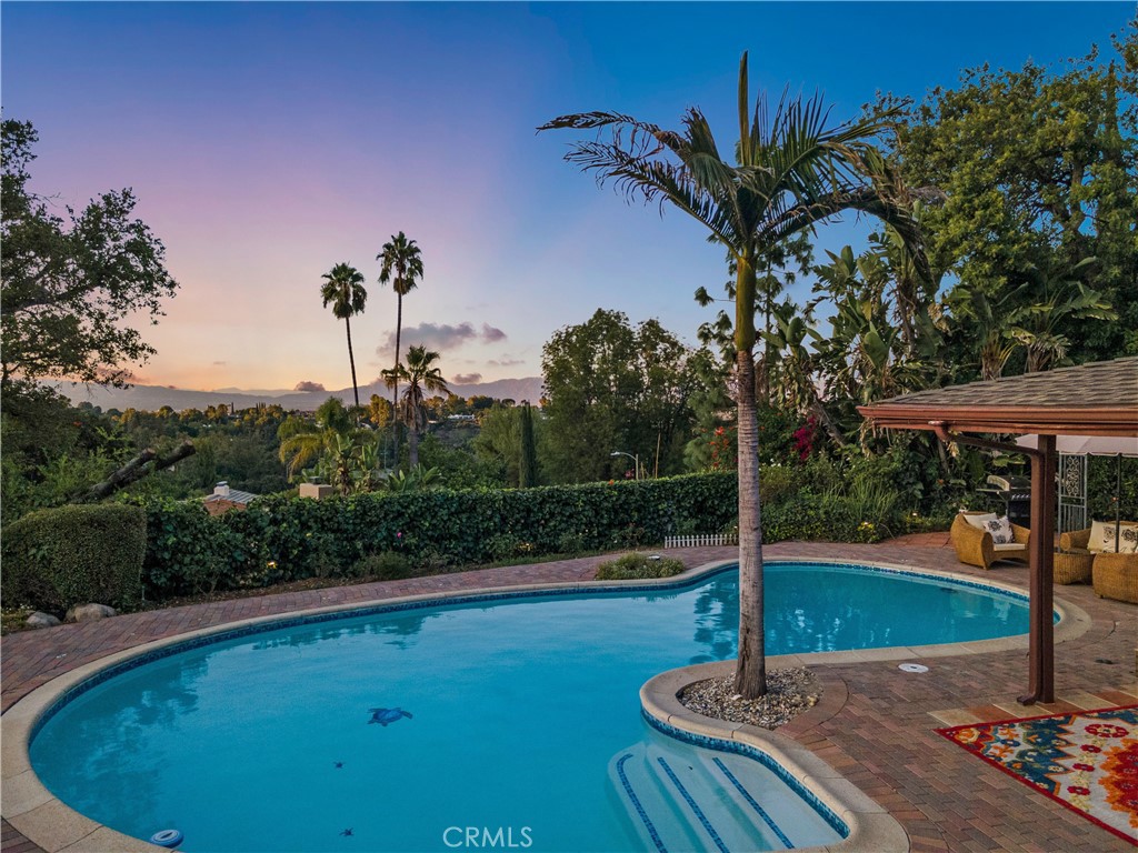 3701 Royal Meadow Road Sherman Oaks, CA 91403 - Photo 8 of 15 a swimming pool with lots of tress in front of it