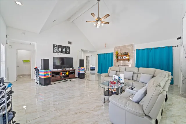 a living room with furniture and a flat screen tv